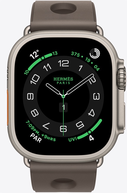 ‏Apple Watch Hermès Ultra 3 بإطار من التيتانيوم الطبيعي، وواجهة الساعة Hermès Circulaire، الإضافات: الطقس، وحلقات النشاط، وPAR، مؤشر الأشعة فوق البنفسجية، والجزء الخارجي الأيمن يُظهر التاج الرقمي، والميكروفون، والزر الجانبي نافر، وحزام Scub'H Diving بلون Gris Titane‏