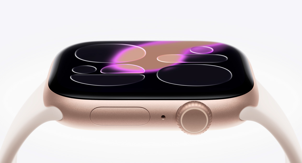 Apple Watch Series 11, rose gold color, aluminum case, Responsive Art watch face, right side exterior, Digital Crown, microphone, side button, Sport Band, light blush color