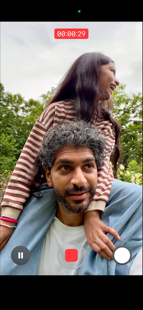 iPhone 17 screen demonstrating stabilized video recording as man carries young girl on his shoulders