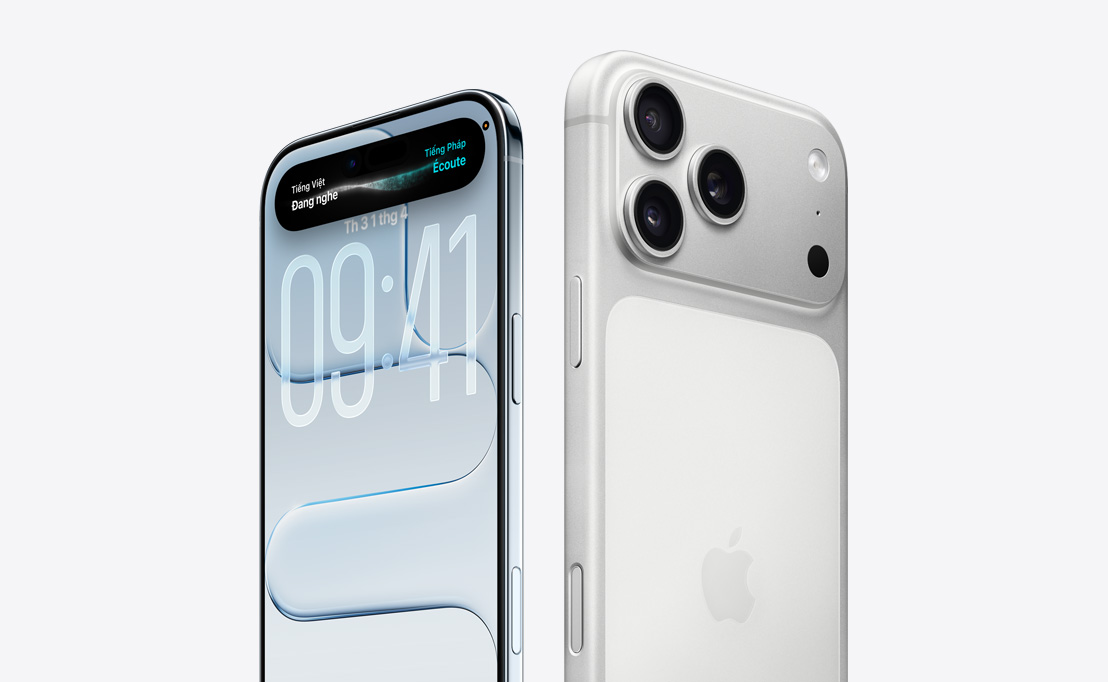 Mặt sau của iPhone 16 Pro Titan Sa Mạc với ba ống kính camera, đứng sau một iPhone 16 Pro khác đang thể hiện nổi bật các tính năng của Dynamic Island trên màn hình.